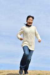 Japanese girl running in the blue sky