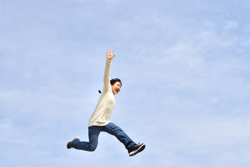 Obraz premium Japanese girl jumping in the blue sky