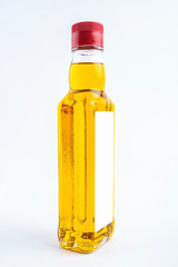 a bottle of golden linseed oil on a white background
