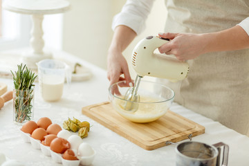 woman preparing cream for homemade cake, close up cropped photo