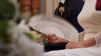  Wedding bride fanning herself in church