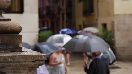 People with umbrellas on a rainy autumn day