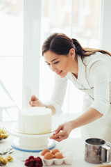 Obraz na płótnie Canvas lovely girl making cake beautiful, close up side view photo