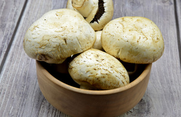 mushrooms in a bowl on wooden background