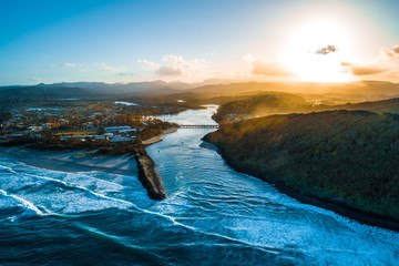 Aerial landscape of Tallebudgera river and Palm Beach suburb at sunset. Gold Coast, Queensland, Australia