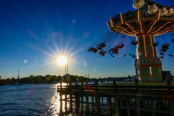 Fototapeta na wymiar Stockholm, Sweden People enjoying the swings at the amusement park called Gröna Lund.