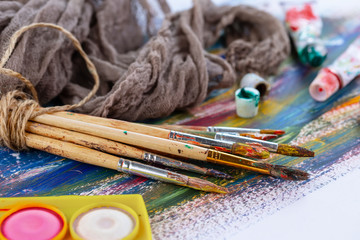 Paint brushes and paints for drawing.