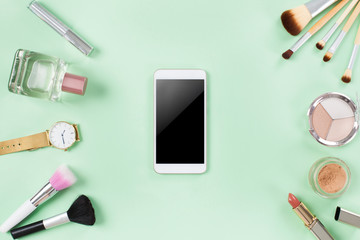 Set of make up brushes and cosmetics with smart phone