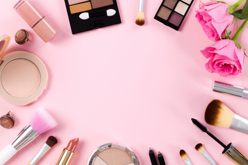 Makeup products on a pink background