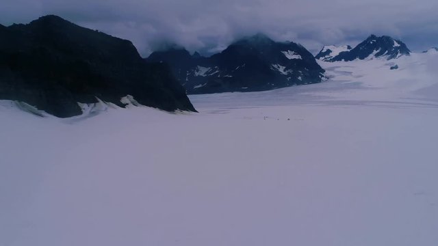 Far away aerial of a dogsled camp on an Alaskan glacier.