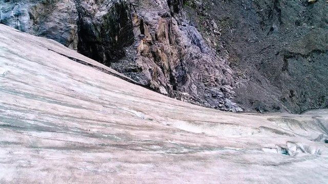Aerial glacier to rockface view of Alaska.