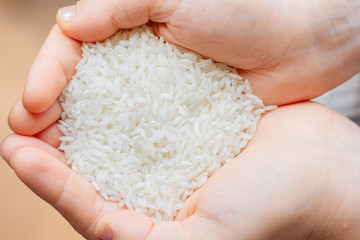 Woman hands holding a white rice.