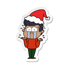 sticker cartoon of a crying man wearing santa hat