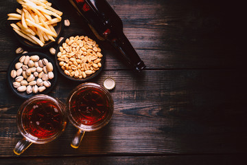 beer and snacks. friday party atmosphere, craft brewery, bar table. restaurant, pub, food concept. delicious lager drink and salted nuts