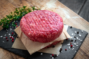 Fresh Ground premium beef Burger cutlets homemade on wooden cutting board