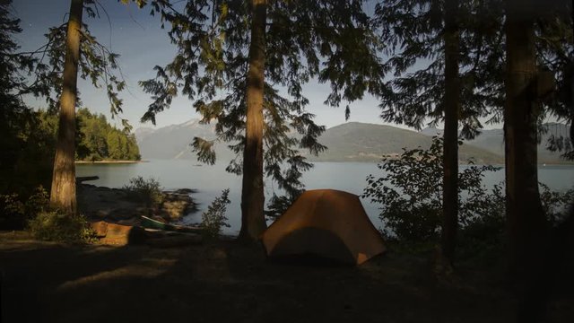 Timelapse of Moonlight Creeping Across Camp Site and Tent on the Lake Front