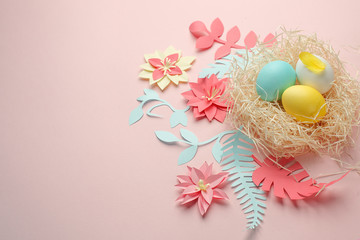 Origami paper color Easter flowers, eggs in the nest on the color background, Ester greeting card, origami paper flower, copy space