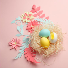 Origami paper color Easter flowers, eggs in the nest on the color background, Ester greeting card, origami paper flower