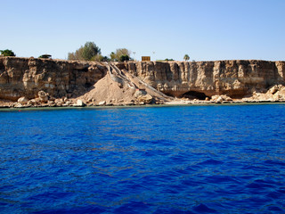 Blue sea and rocky shore. The rocky coast of the red sea, Sharm El Sheikh.