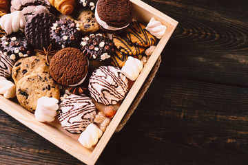 chocolate chip cookies, biscuits, sweets assortment in craft wooden box. sweet food, culinary...