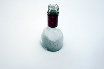 Frozen bottle in the snow