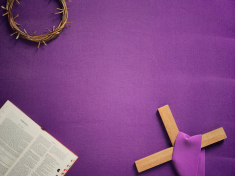 Good Friday, Lent Season And Holy Week Concept - A Religious Cross, A Bible And A Woven Crown Of Thorns On Purple Background.