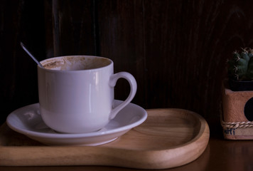 cup of coffee on wooden table
