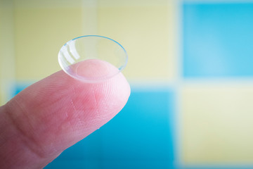 Contact lens on finger, close up.