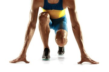 Young caucasian man preparing to run isolated on white studio background. One male runner or...