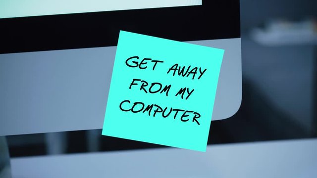 Get Away From My Computer. The inscription on the sticker on the monitor. Message. Motivation. Reminder. Handwritten text written with a marker. Color sticker. A message for an employee, a colleague