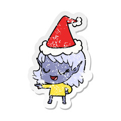 happy distressed sticker cartoon of a elf girl pointing wearing santa hat