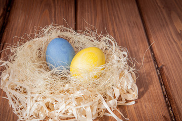 Colorful Easter eggs on wooden background with copy space