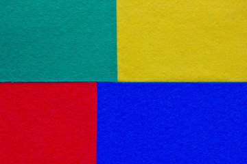 Pieces of coloured felt.Red, turquoise, yellow and  blue color composition. Colorful felt texture for background with copy space.