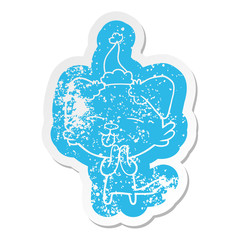 cartoon distressed sticker of a dog sticking out tongue wearing santa hat
