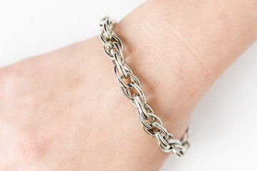 Metal bracelet on the female wrist.