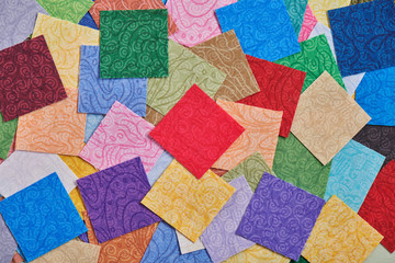 Heap square pieces of colorful fabrics for making quilt