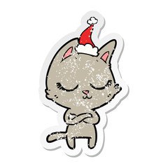 calm distressed sticker cartoon of a cat wearing santa hat
