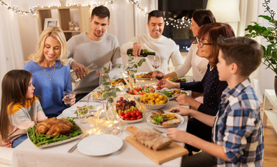 celebration, holidays and people concept - happy family having dinner party at home