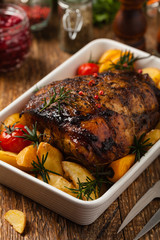 Roasted whole shoulder, with potatoes, peppers and tomatoes. Marinated in white wine.