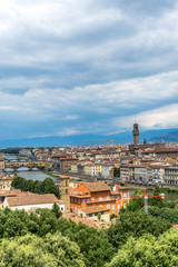 Fototapeta premium Panaromic view of Florence townscape cityscape viewed from Piazzale Michelangelo (Michelangelo Square) with ponte Vecchio and Palazzo Vecchio with lightningPanaromic view of Florence townscape citysca