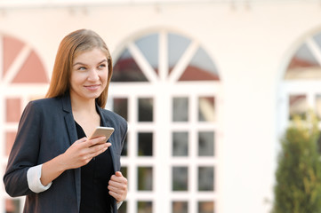 Woman satisfies with accomplished online payment successfully on mobile looking away