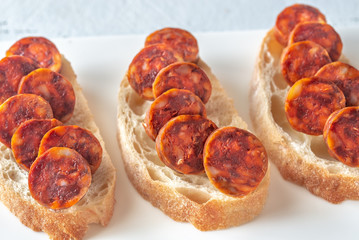 Sandwich with spanish chorizo on the plate