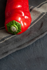 Vertical close-up of pepper on kitchen towel