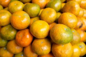 orange fruit stacked on the marketplace
