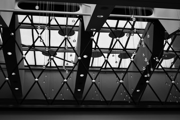 Hotel abstract in monochrome with spheres, lines, geometric shapes lighitng from behind from sun.