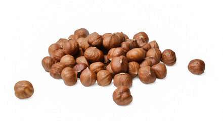 A small pile of peeled hazelnuts on a white isolated background. Side view. Close-up.