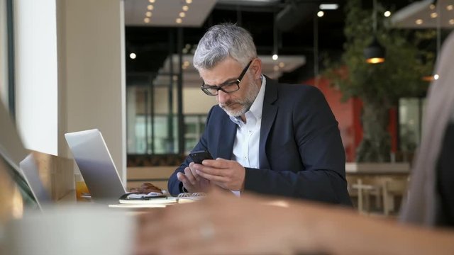 Businessman working during layover at modern airport