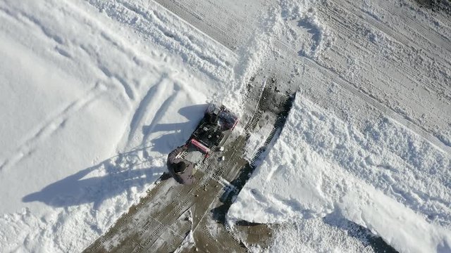 Aerial top view of man sbow blowing with camera spin.