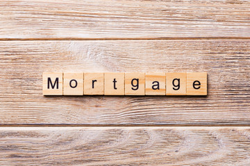 MORTGAGE word written on wood block. MORTGAGE text on wooden table for your desing, concept