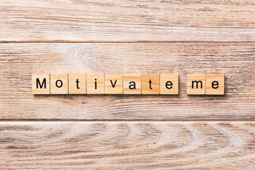 Motivate me word written on wood block. Motivate me text on wooden table for your desing, concept